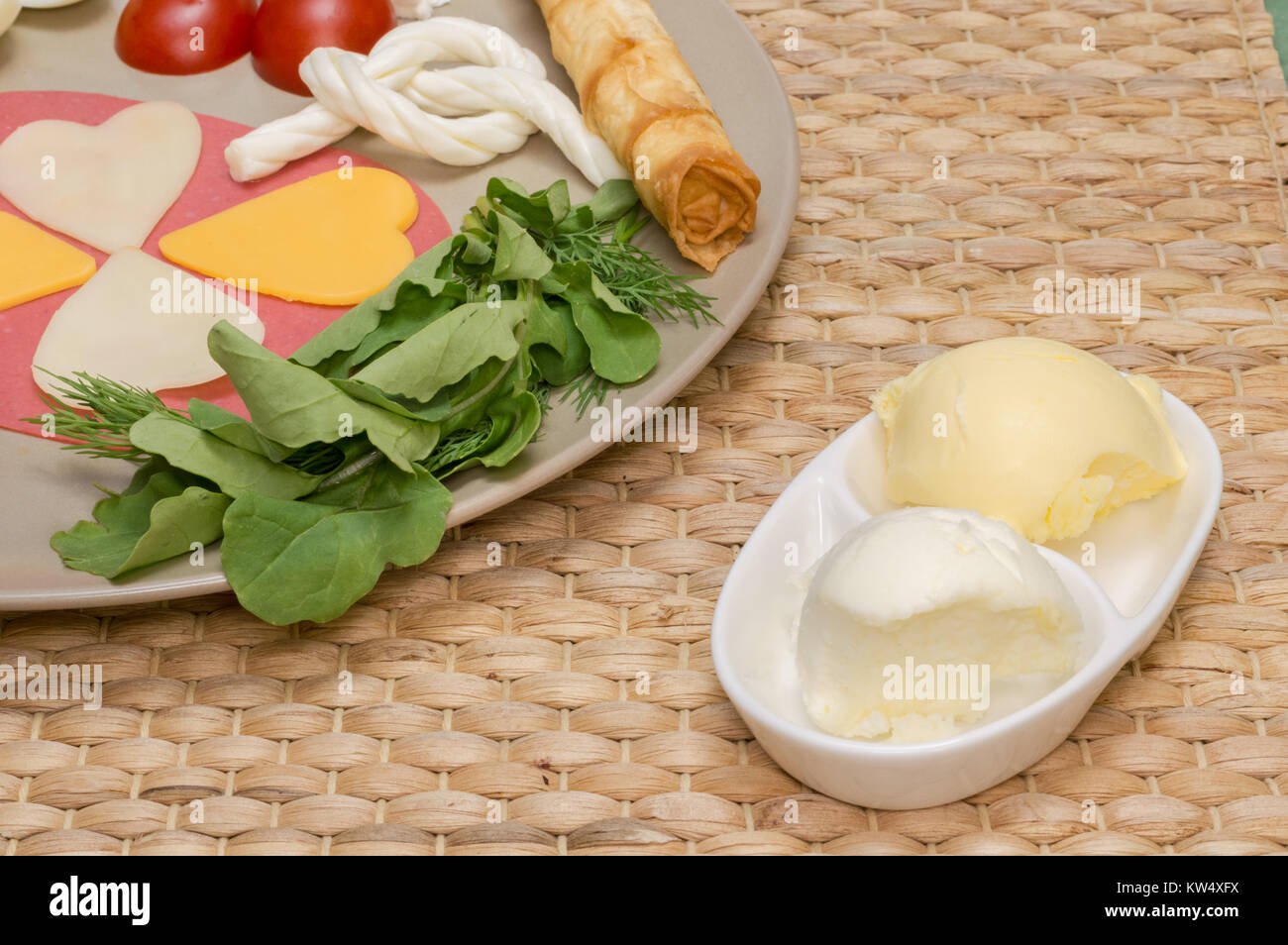 Close up of traditional Turkish breakfast served on porcelain plate with  cheese, salami, patty, tomato, and rockets Stock Photo