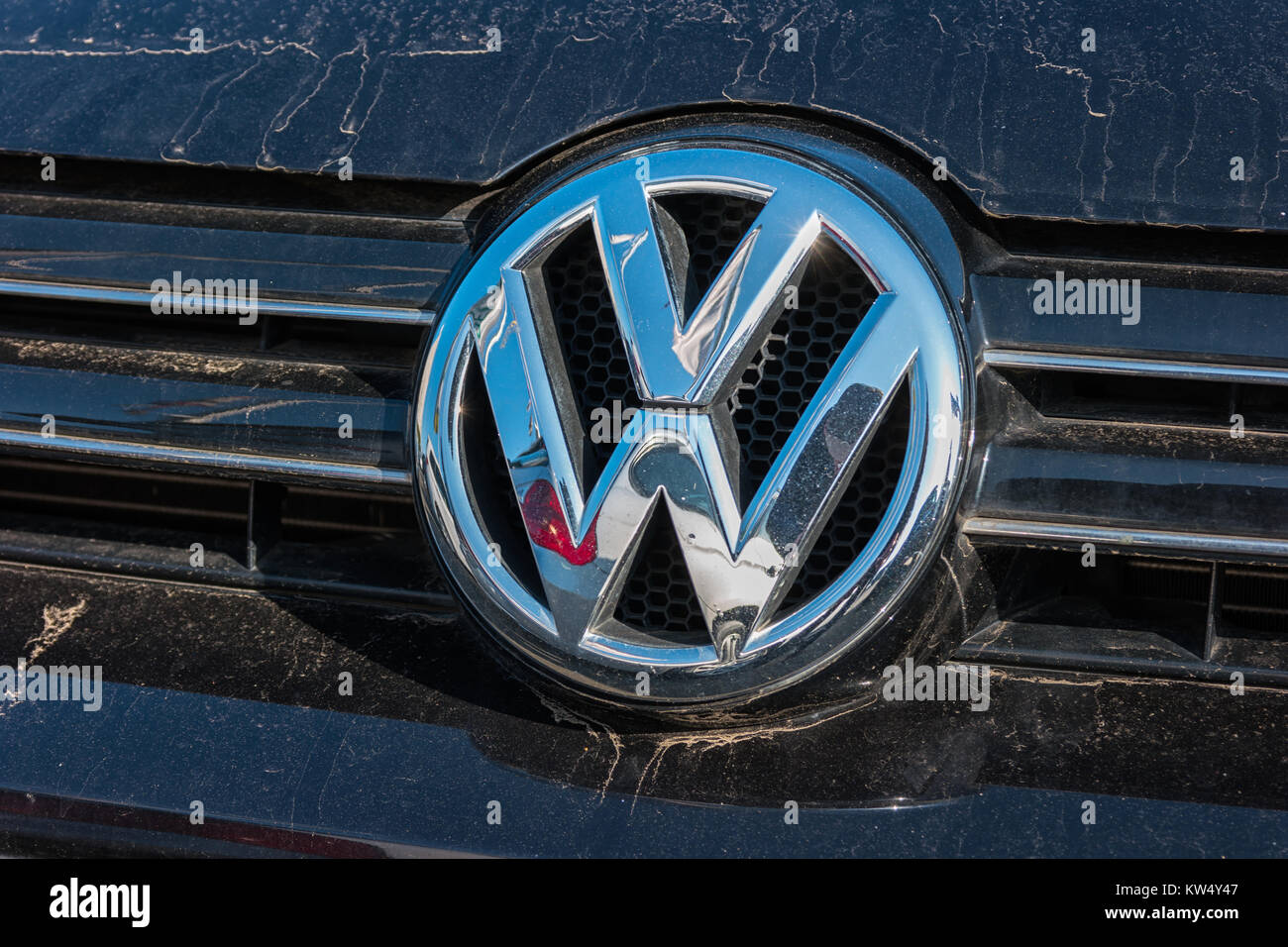 Dirty Sign of a Volkswagen logo on a car. Volkswagen is a company of the Volkswagen Group. Stock Photo