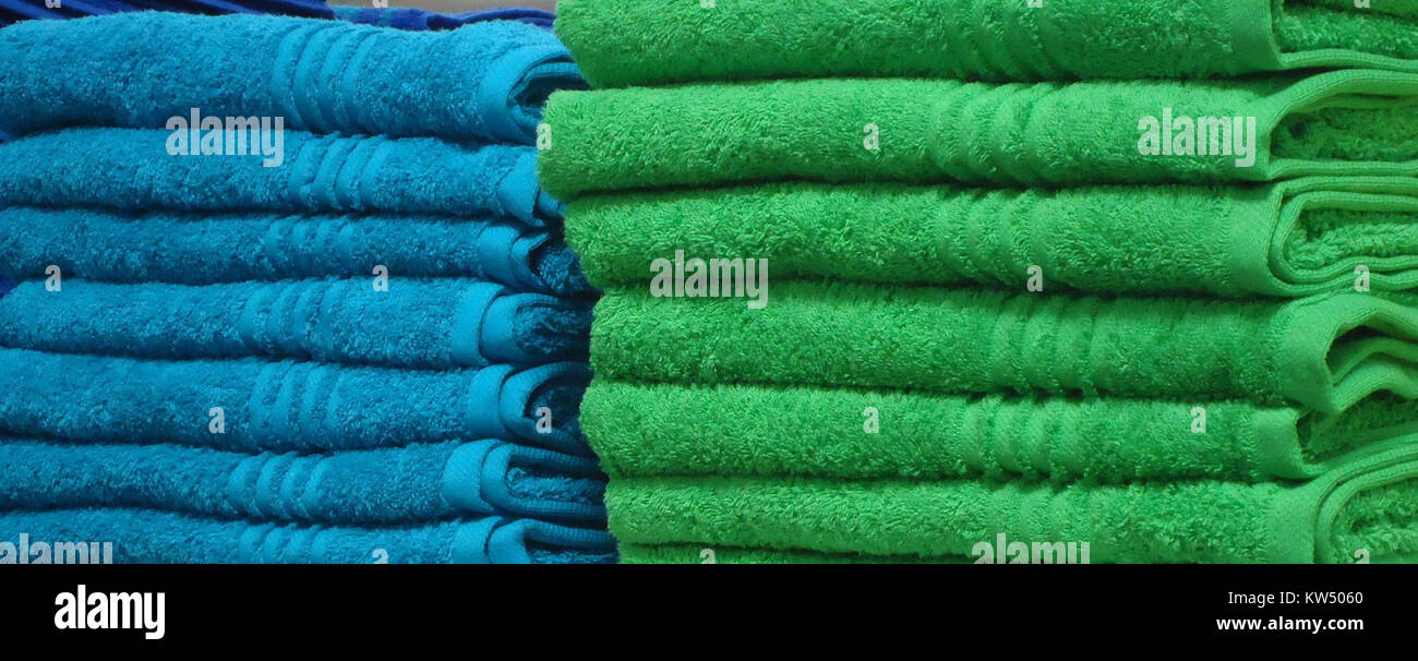 Blue and green towels on a shelf in a store in New Jersey Stock Photo