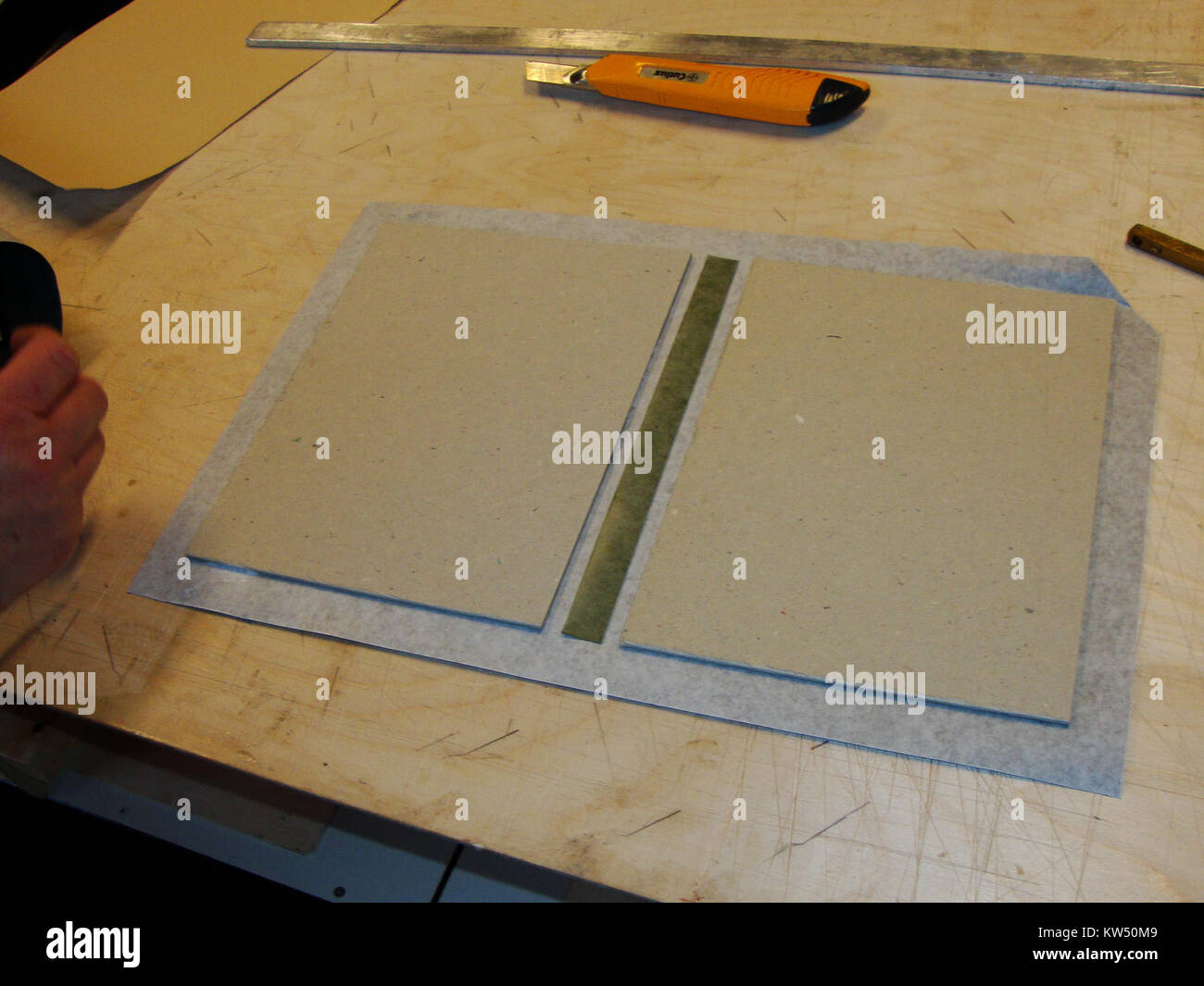 The Boekbindclub Dukenburg Z13 focuses on bookbinding techniques, specifically using linen with a 2 cm fold for book covers, highlighting craftsmanship and the art of bookbinding. Stock Photo