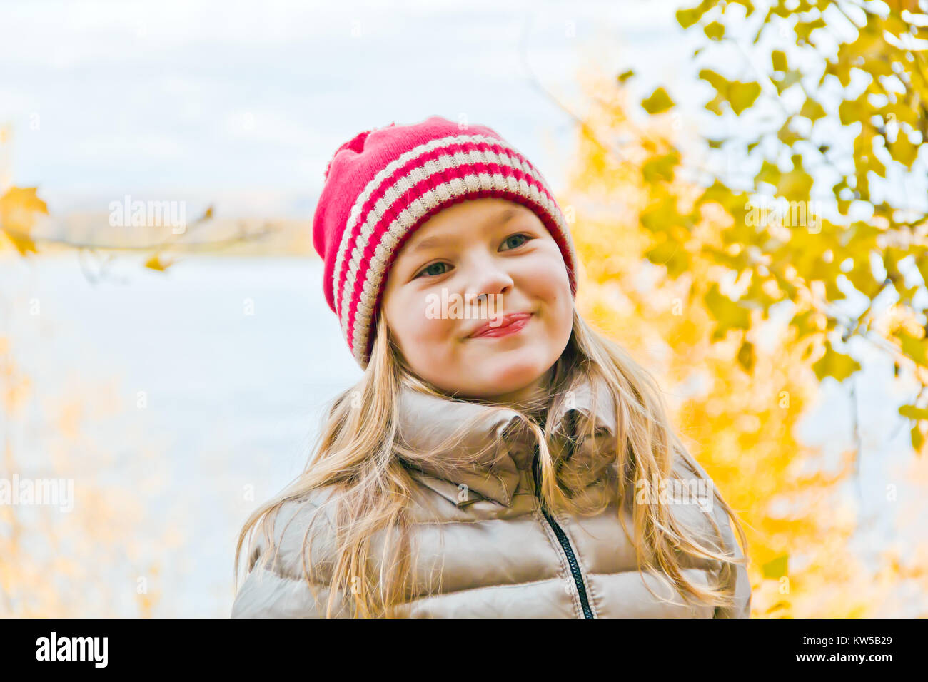 Photo of cute smiling girl in autumn Stock Photo - Alamy