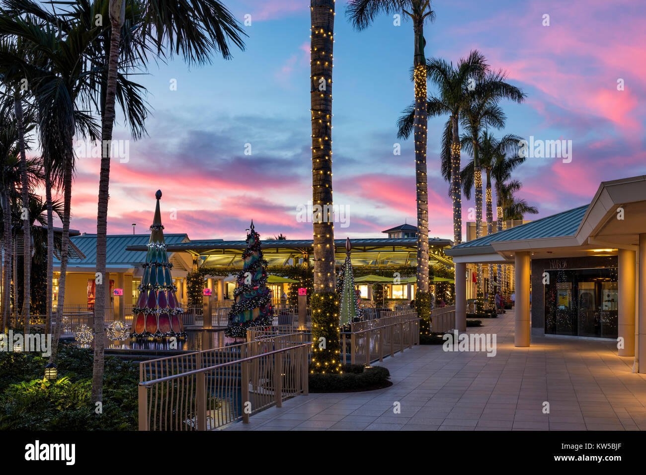Christmas decorations and colorful sunset at the Waterside Shops - an upscale open-air mall, Naples, Florida Stock Photo
