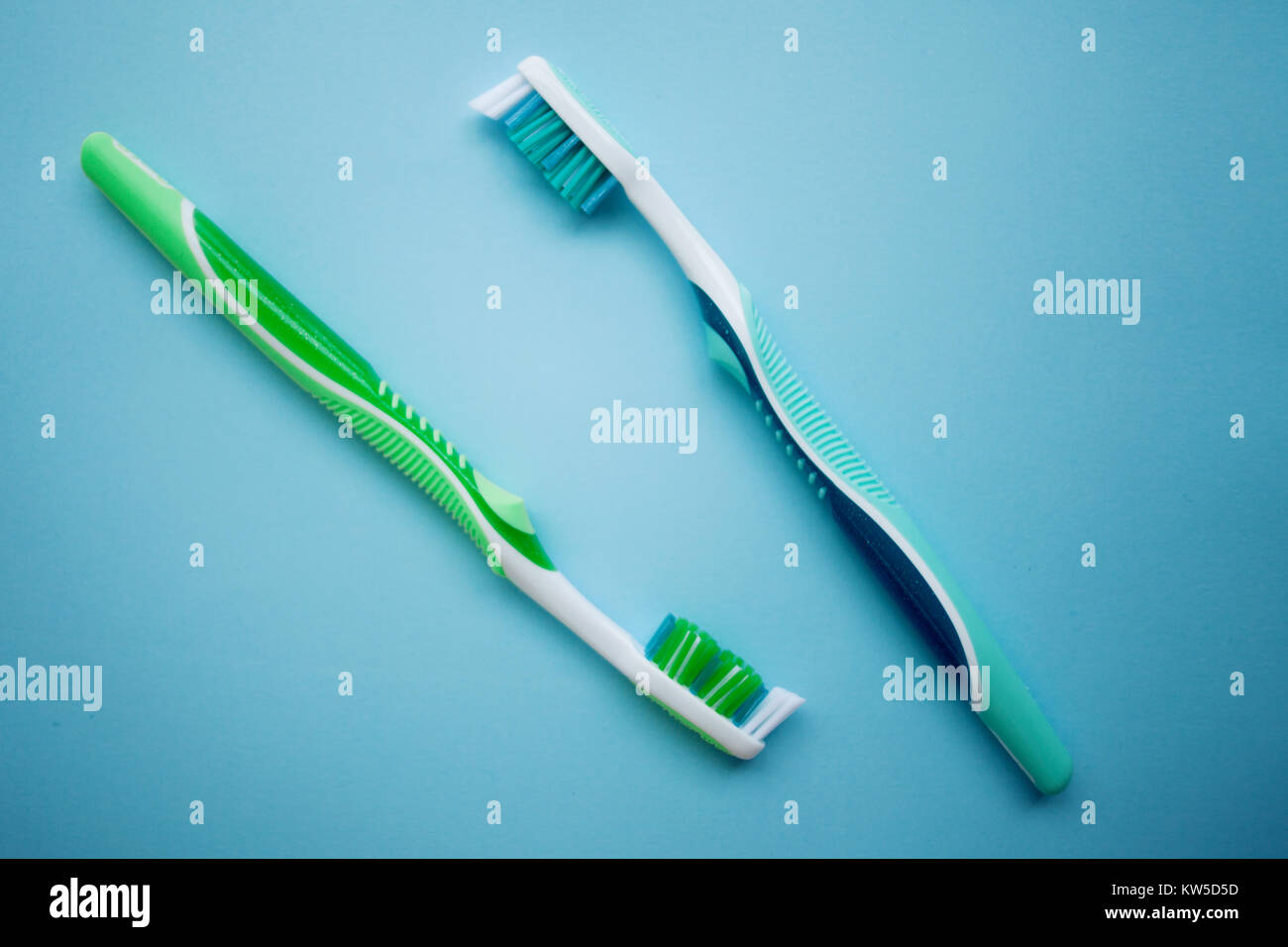 Two toothbrushes on blue background, top view Stock Photo - Alamy