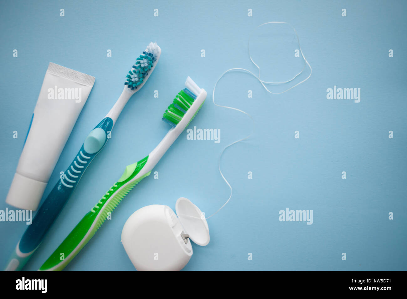 Two toothbrushes and dental floss on blue background, top view Stock ...
