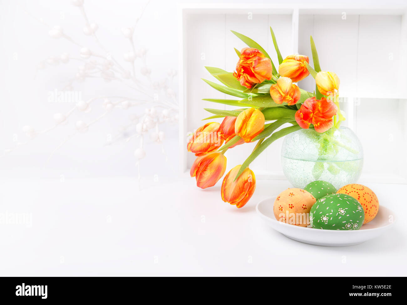 Easter greeting card design with bunch of tulips and painted eggs on ...
