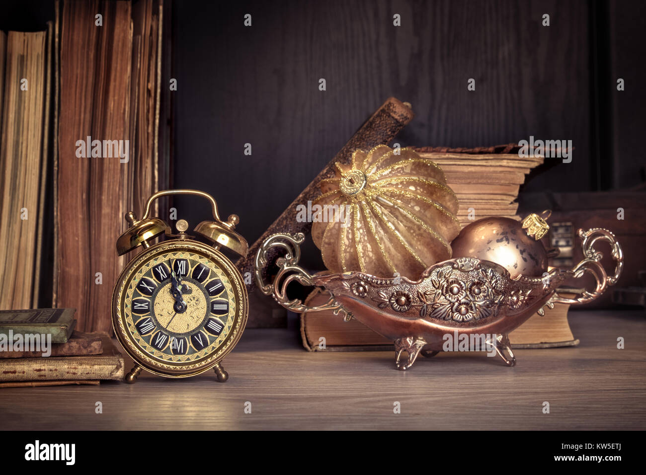 Vintage Alarm Clock Showing Five To Twelve With Old Books And