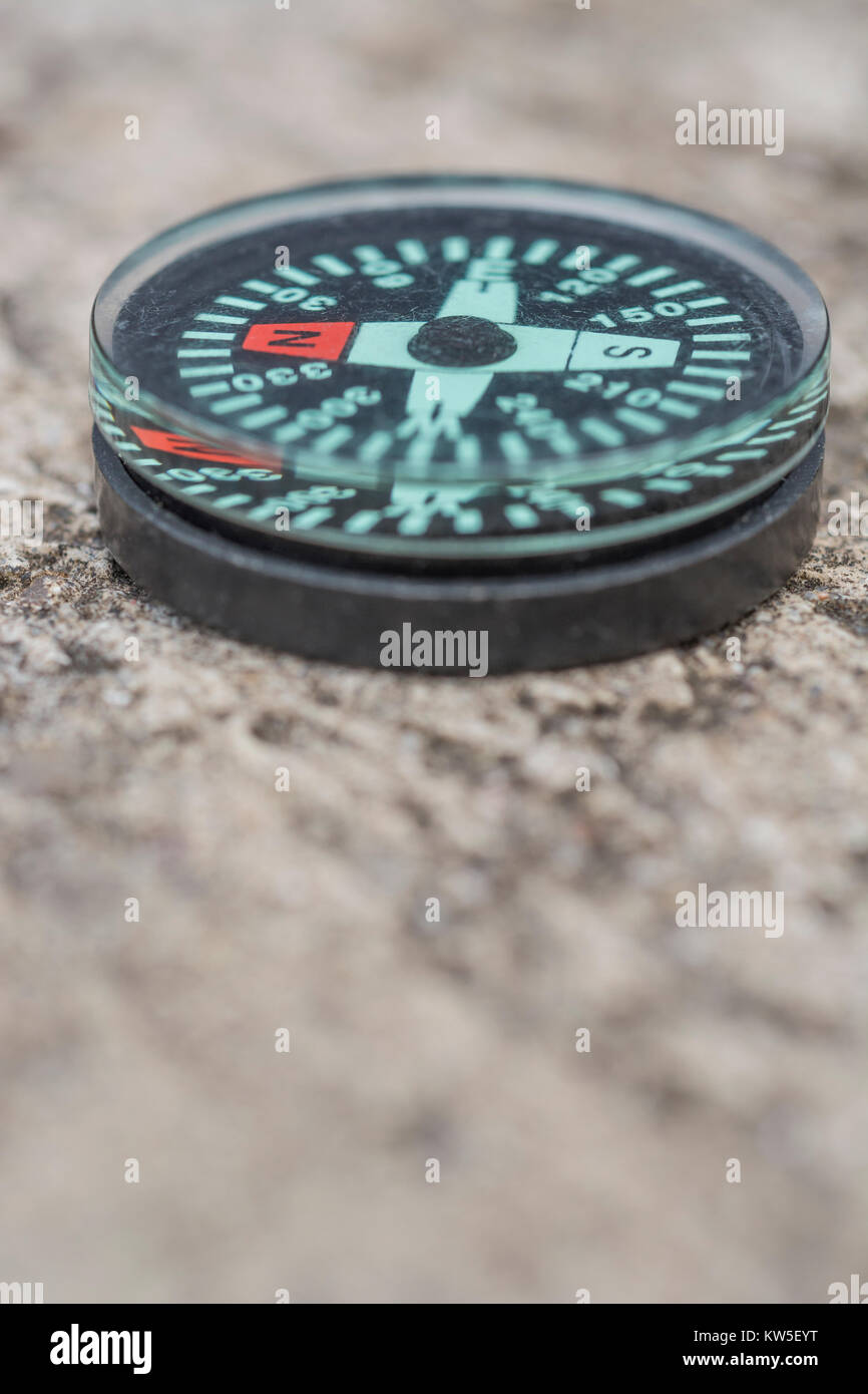 Button compass - metaphor for business 'direction', navigation, moral compass, getting your bearings concept, orienteering - with copy space. Stock Photo