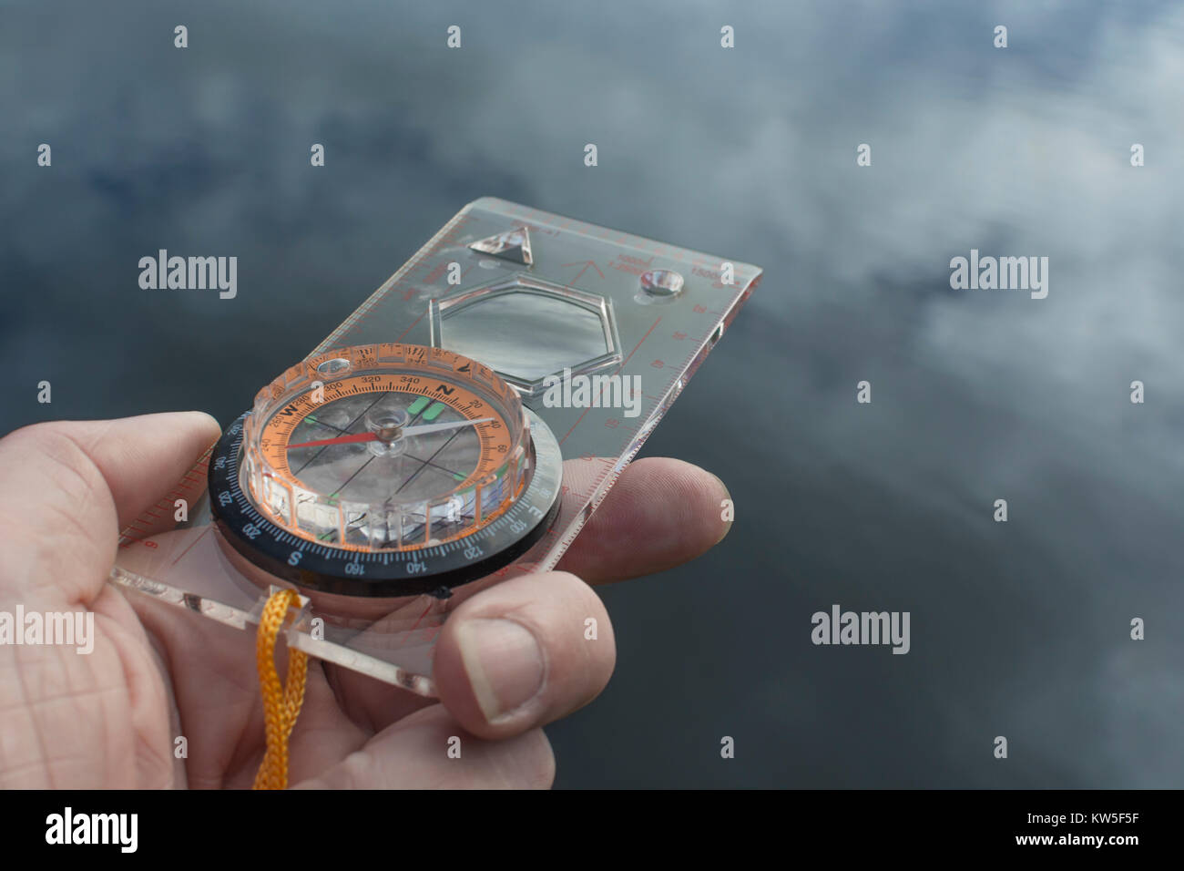 Orienteering compass in hand for business 'direction', navigation