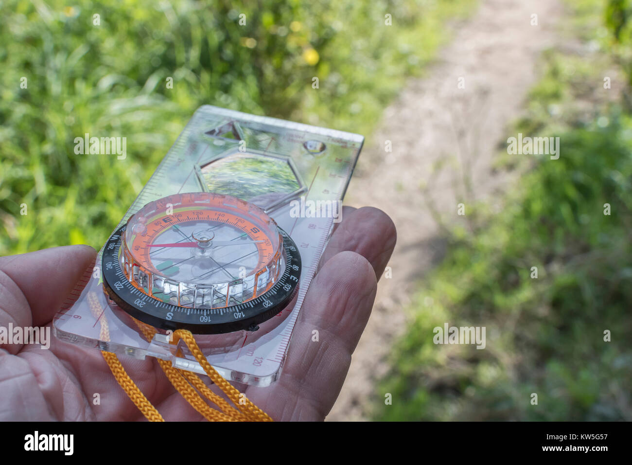 Orienteering compass in hand for business 'direction', navigation