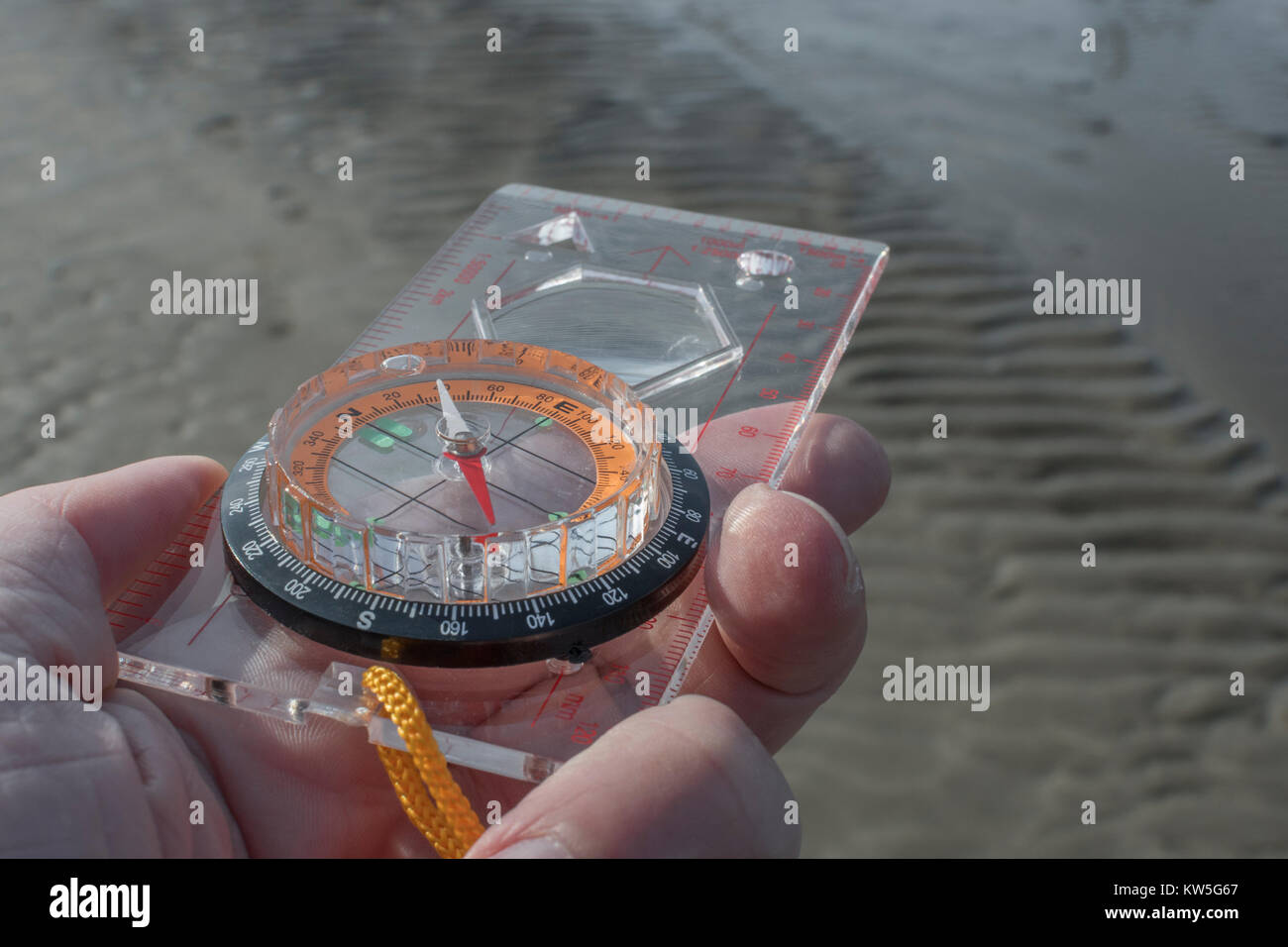 Orienteering compass in hand for business 'direction', navigation, moral compass, getting your