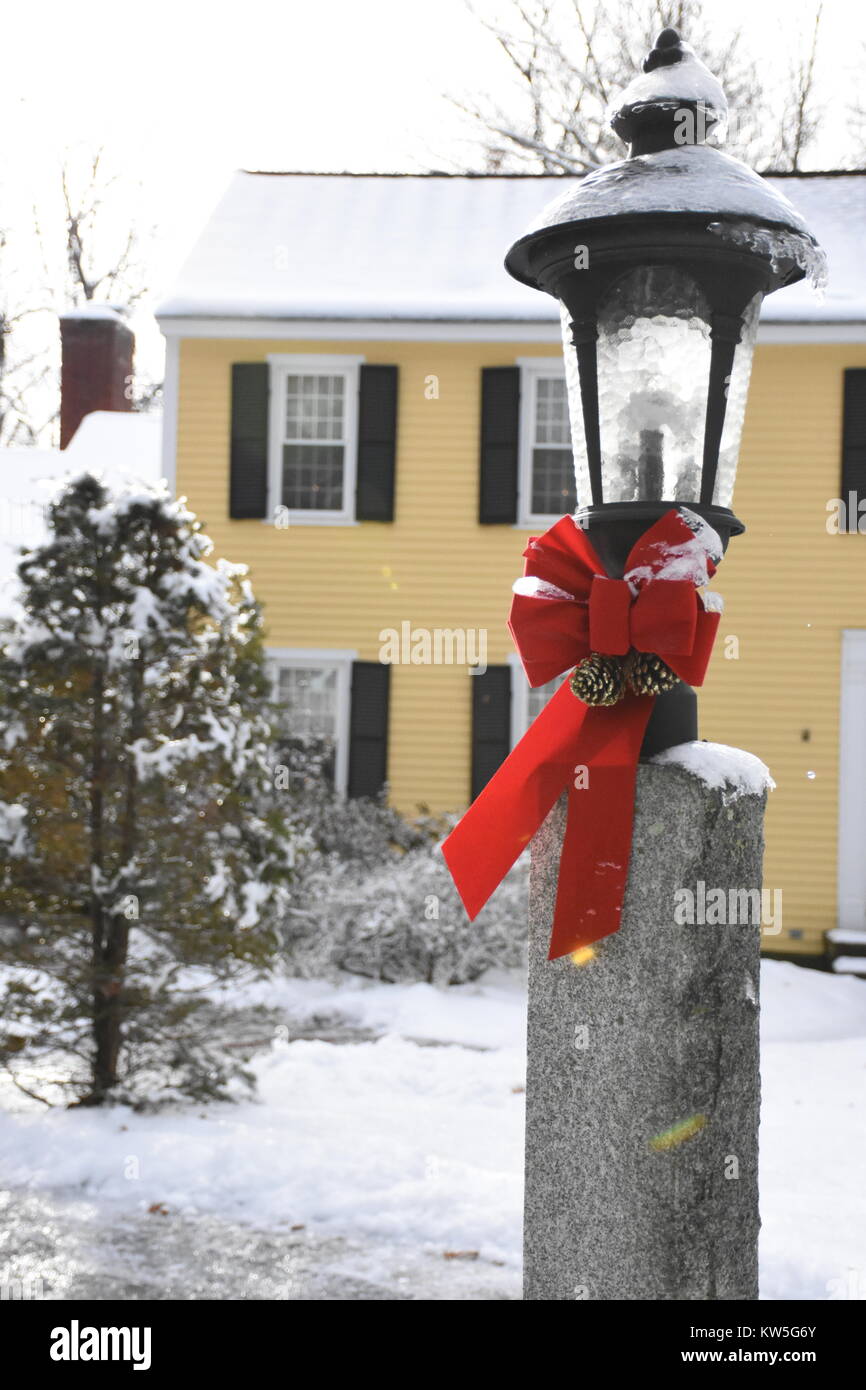 Drip coming off granite lightpost after mix of snow and freezing rain. Stock Photo