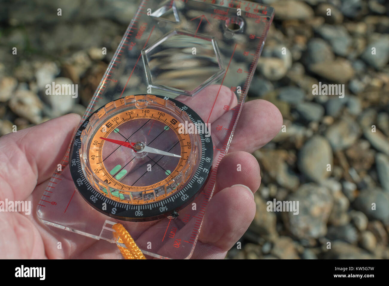 Orienteering compass in hand pointing east. For business direction