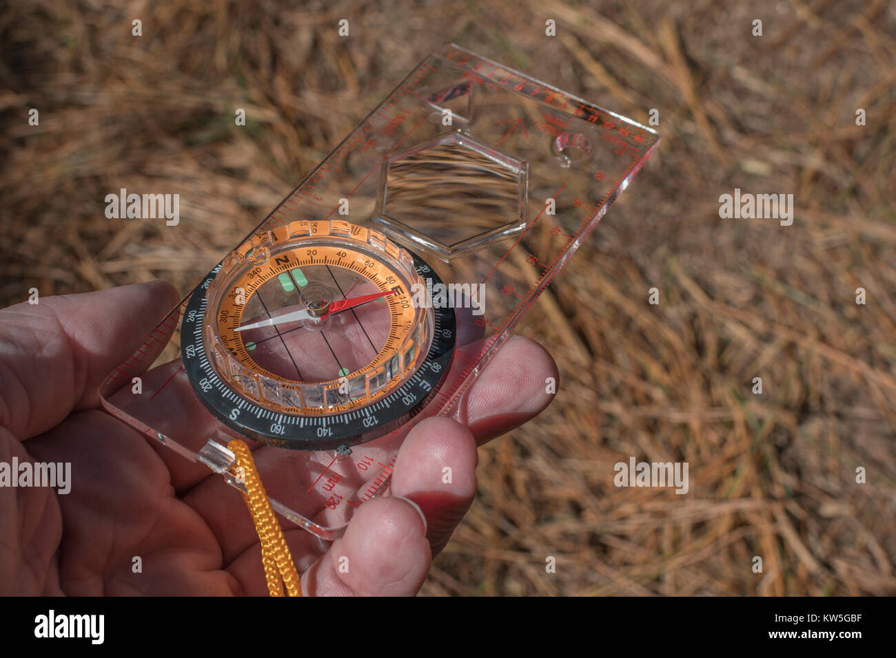 Orienteering compass in hand pointing east. For business 'direction