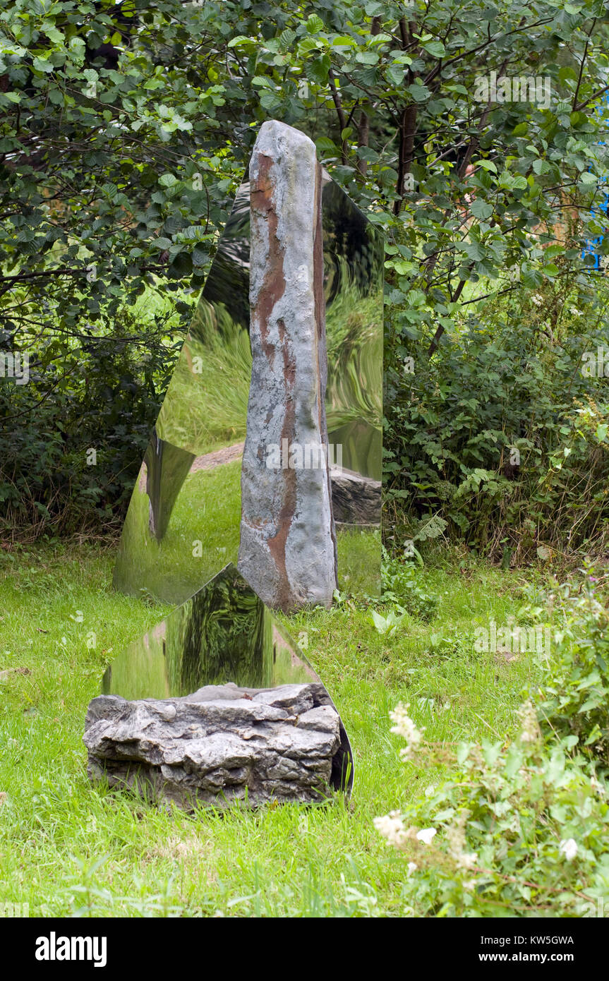 Landscape sculpture of Upright stone reflected in mirror Stock Photo