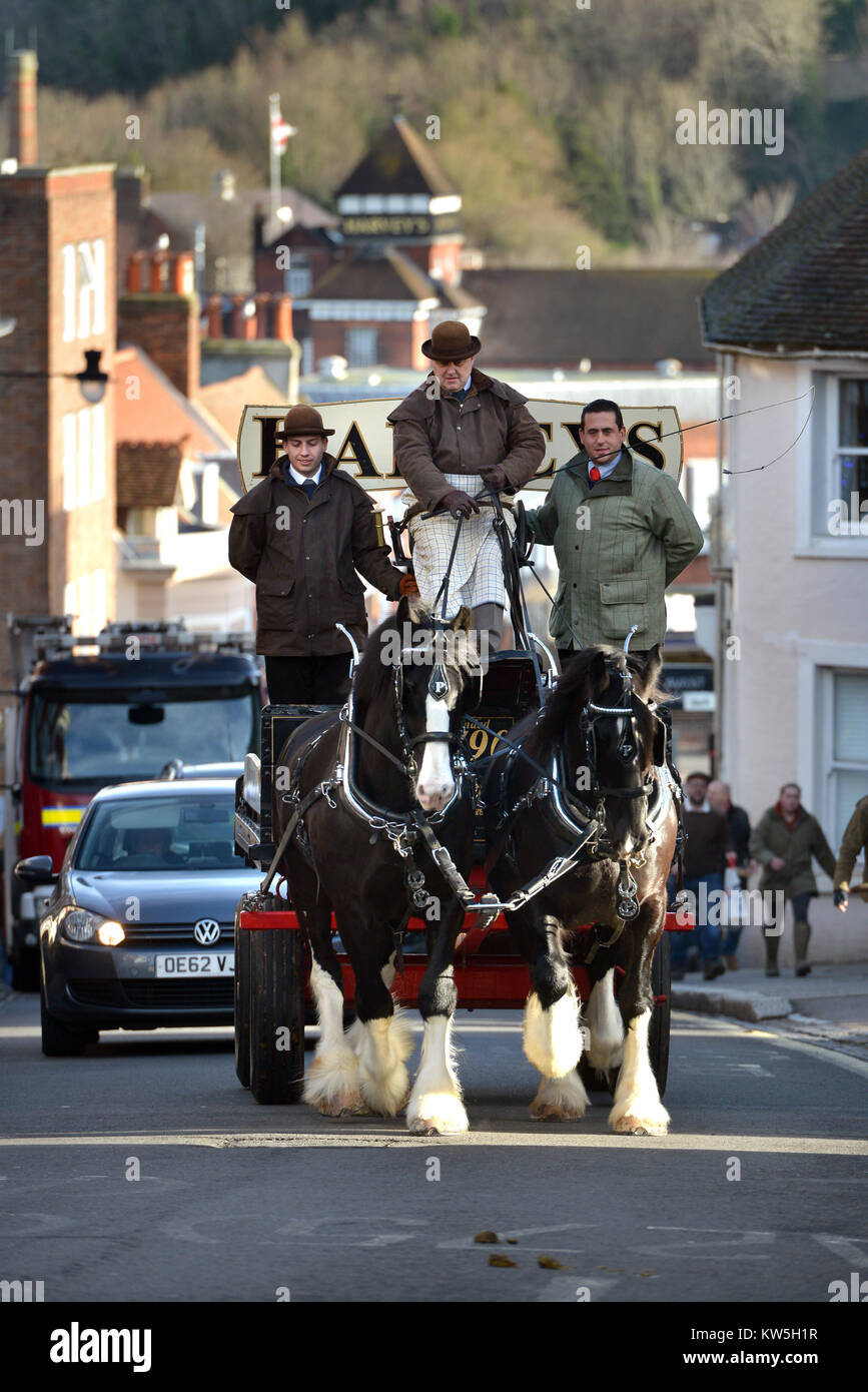 Ale delivered by dray horse in Lewes, East Sussex. Harvey's Brewery (in background) regularly delivers ale to local pubs by using a horse and cart Stock Photo