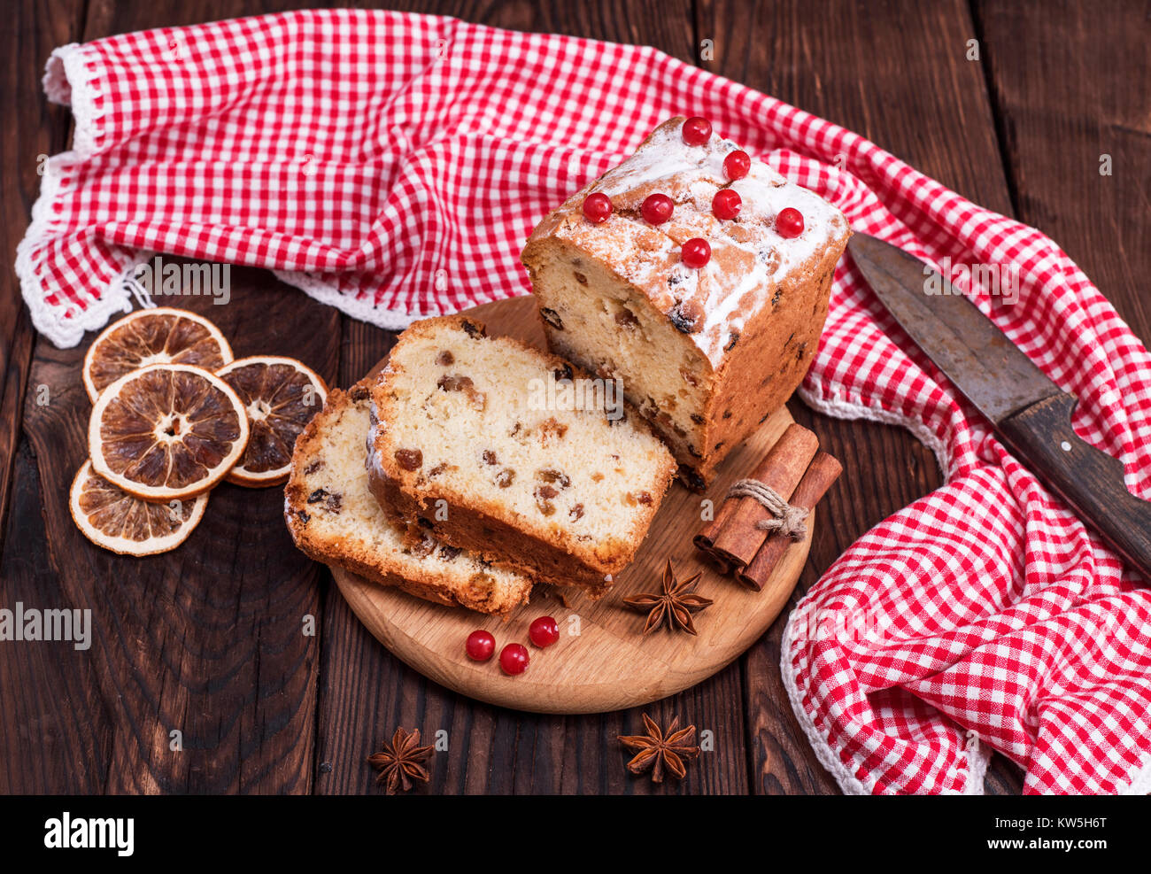 rectangular fruit cake cut into slices on a wooden board, top view ...