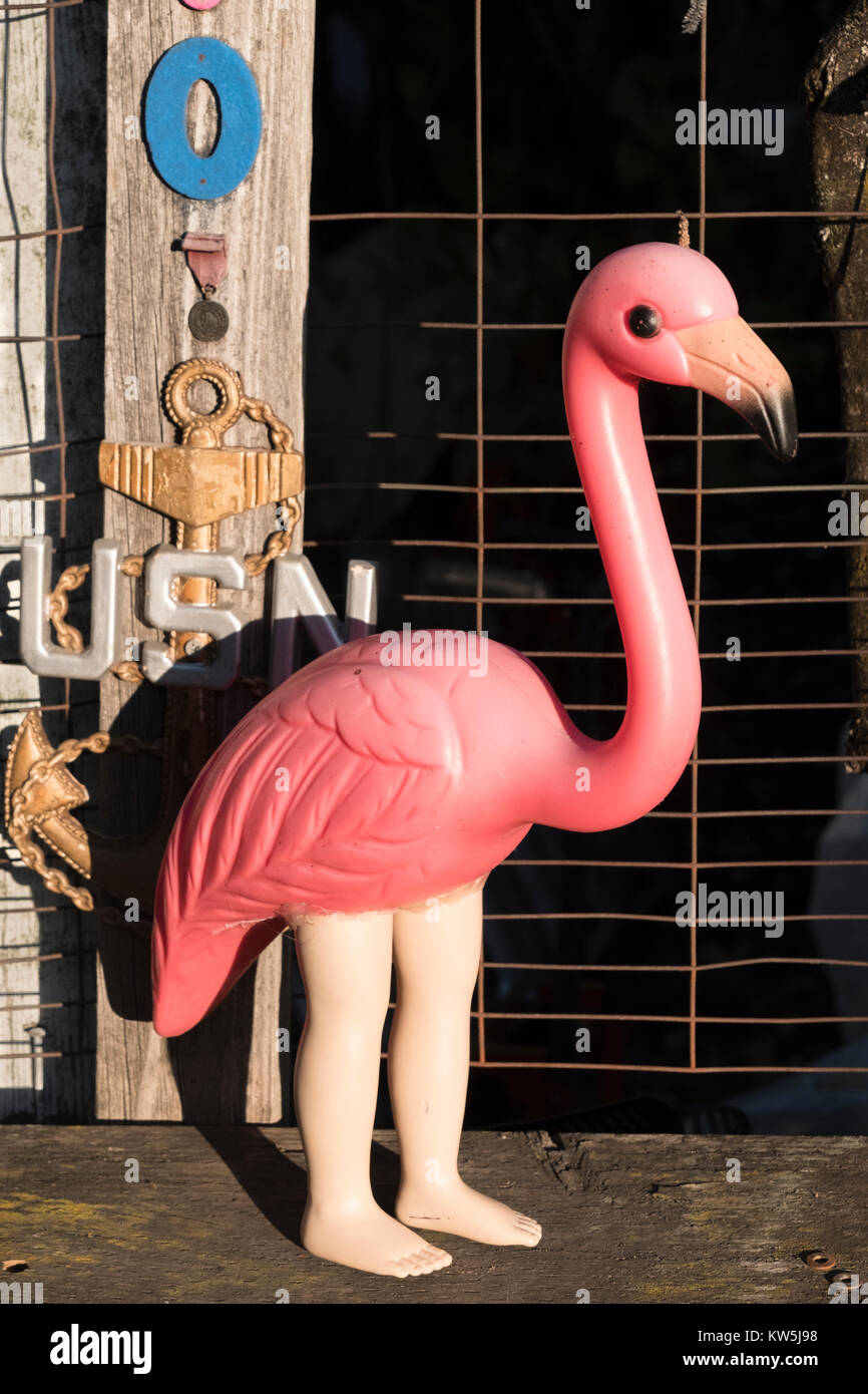 A plastic flamingo with human legs Stock Photo