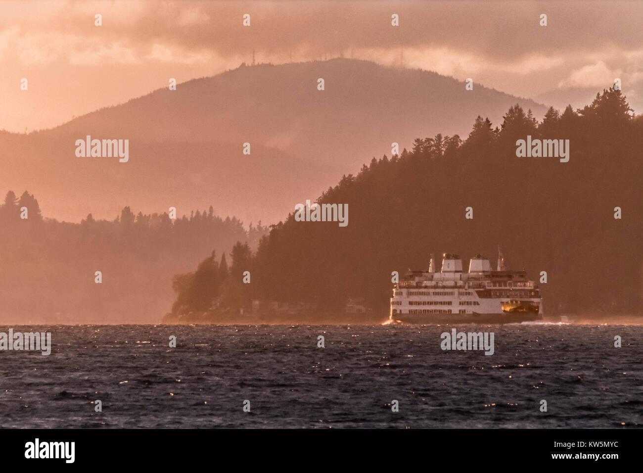 Ferryboat crossing Puget Sound  from Seattle to Bemerton at sunset, Washington, USA Stock Photo