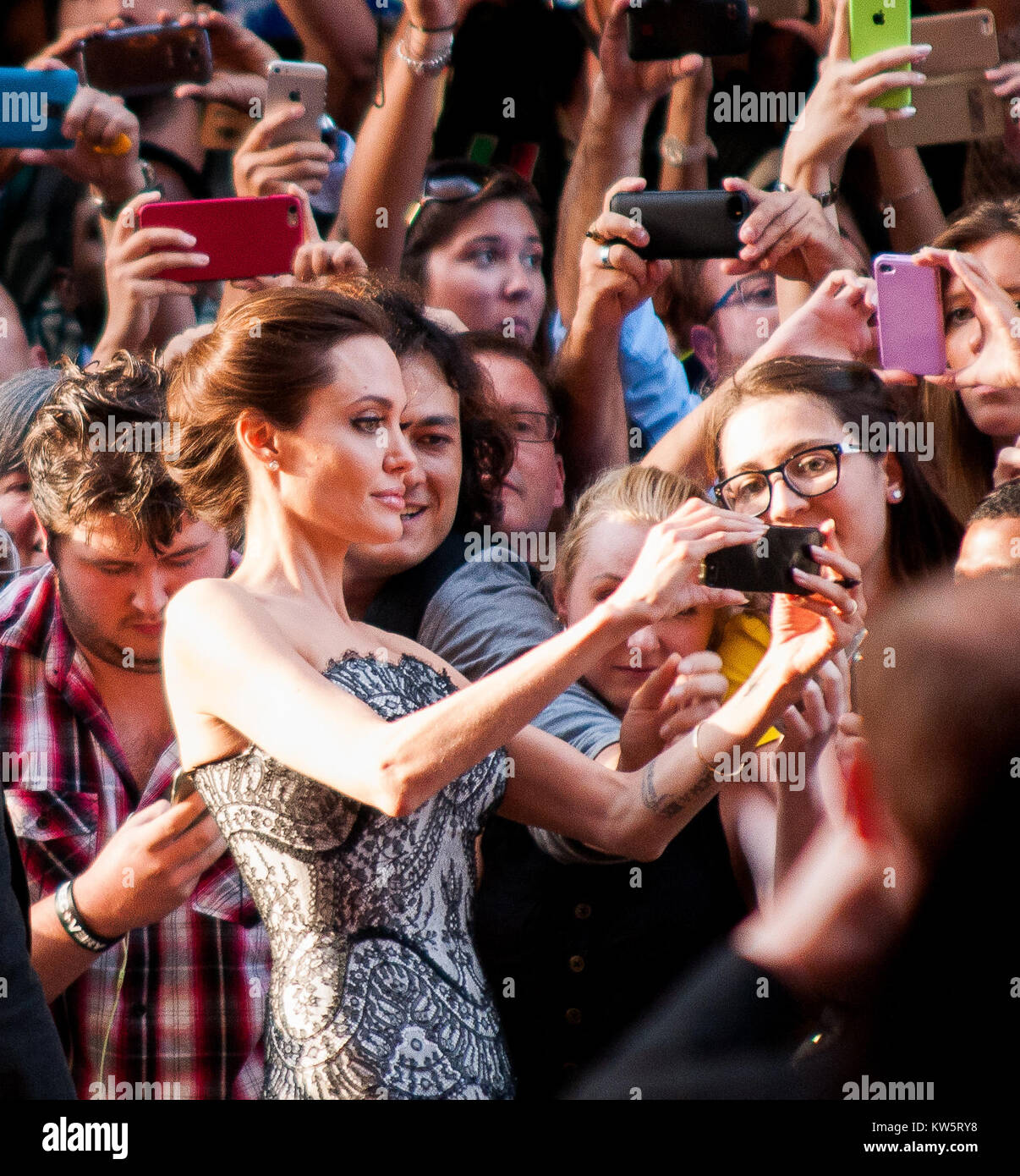 SYDNEY, AUSTRALIA - NOVEMBER 18: Miyavi Ishihara, Angelina Jolie and Jack O'Connell, at the photo call of Unbroken at Sydney Opera House on November 18, 2014 in Sydney, Australia.  People:  Angelina Jolie Stock Photo