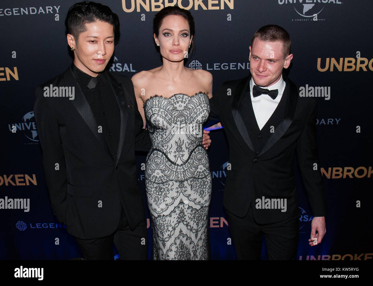 SYDNEY, AUSTRALIA - NOVEMBER 18: Miyavi Ishihara, Angelina Jolie and Jack O'Connell, at the photo call of Unbroken at Sydney Opera House on November 18, 2014 in Sydney, Australia.  People:  Miyavi Ishihara, Angelina Jolie, Jack O'Connell Stock Photo