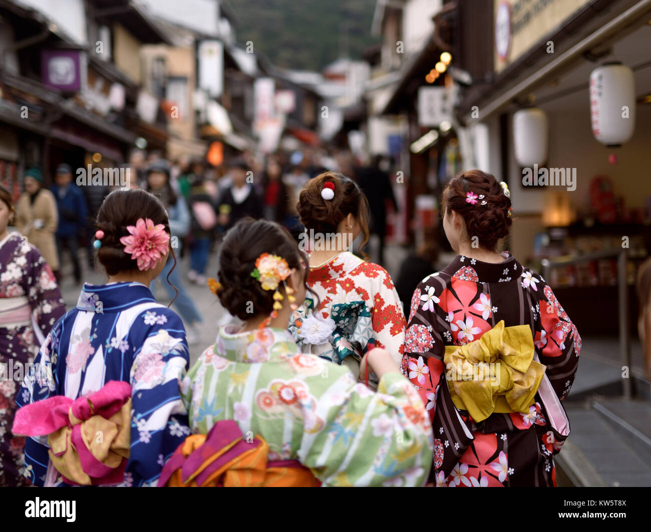 License and prints at MaximImages.com - girls in bright Yukata kimonos with their obi tied in a bow walking down Yasaka dori street in Kyoto Stock Photo