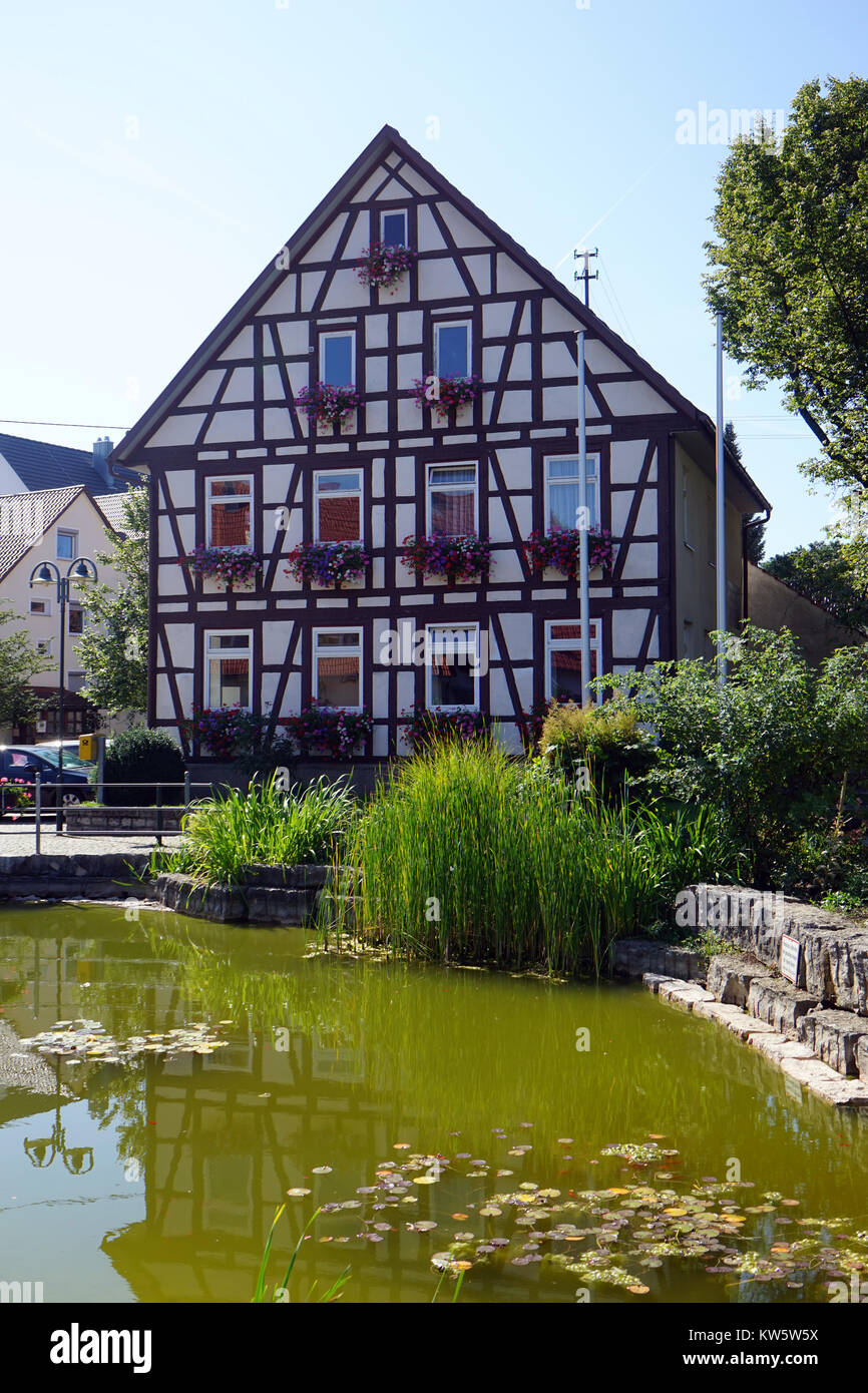 OCHSENWANG, GERMANY - CIRCA AUGUST 2015 Fachwerk house near green pond Stock Photo