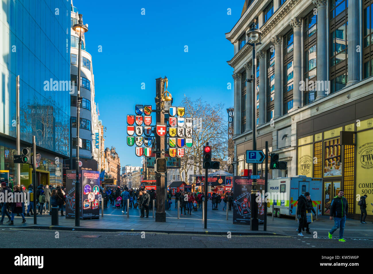 LONDON DECEMBER 28, 2017: Tourists and Londoners enjoy sunny day on Leicester Square, pedestrianised square which is a famous destination for night li Stock Photo