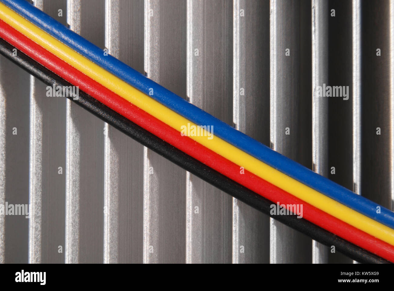 Wires dark blue red yellow and black on a background of a radiator