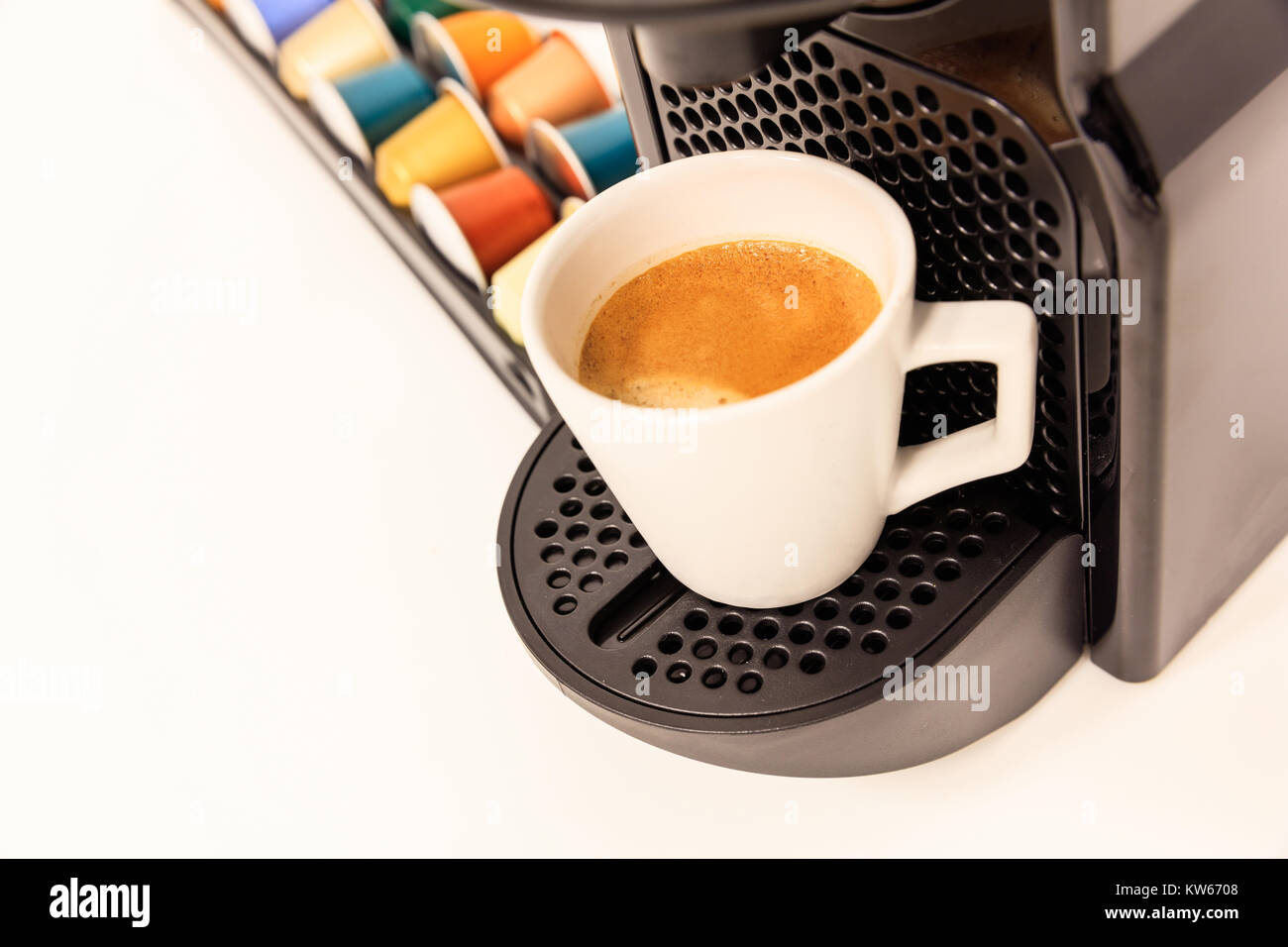 Espresso coffee maker machine. Ready coffee, modern design, capsules near it, closeup view, details. Stock Photo
