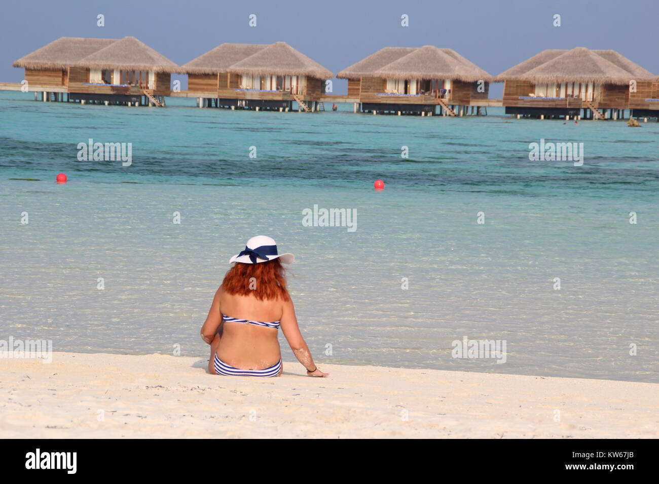 People from the back on beach in the Maldives Stock Photo