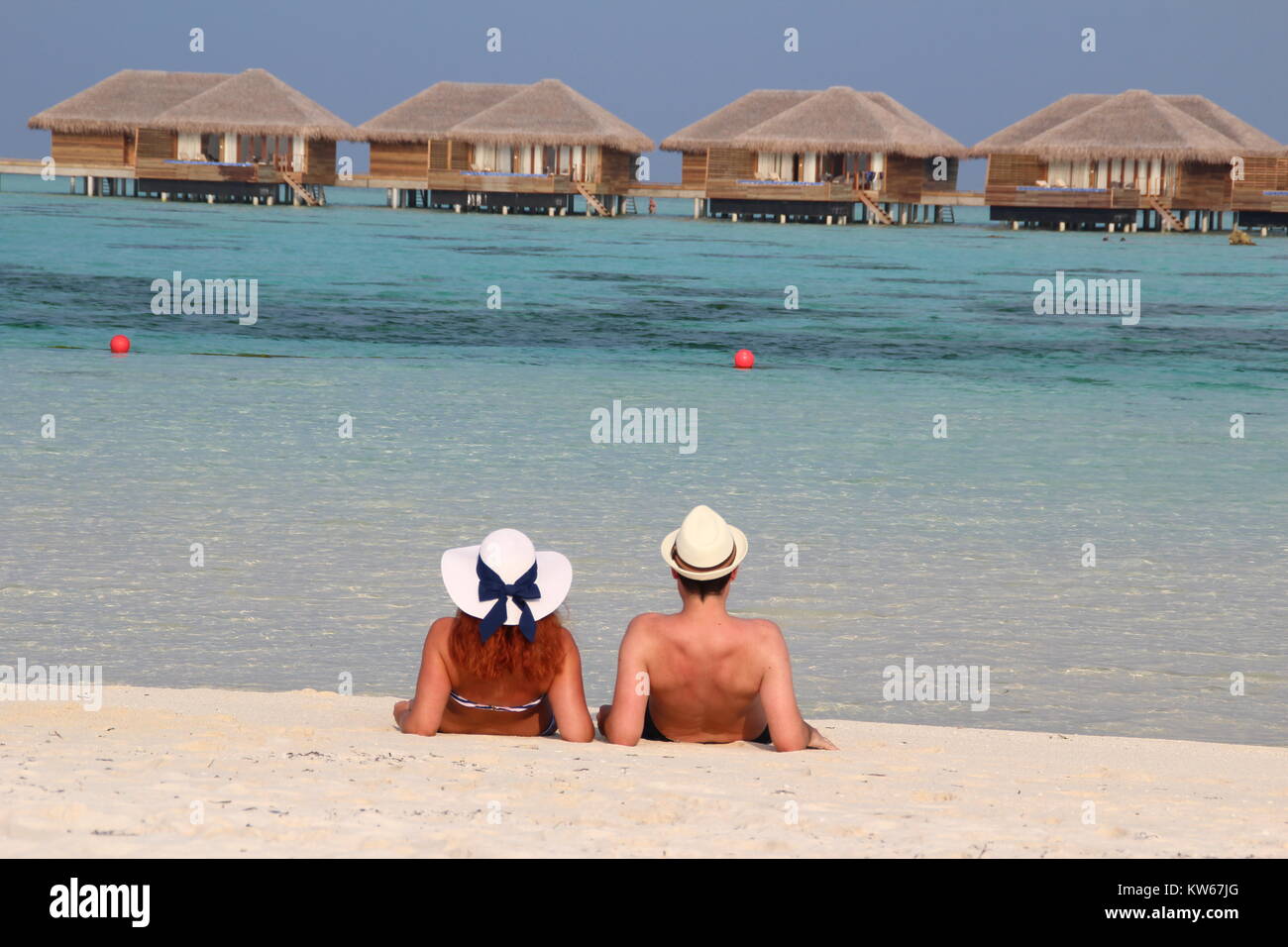 People from the back on beach in the Maldives Stock Photo