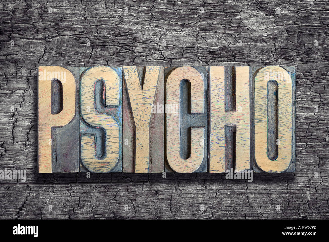 psycho word made from vintage letterpress type on burned wood background Stock Photo
