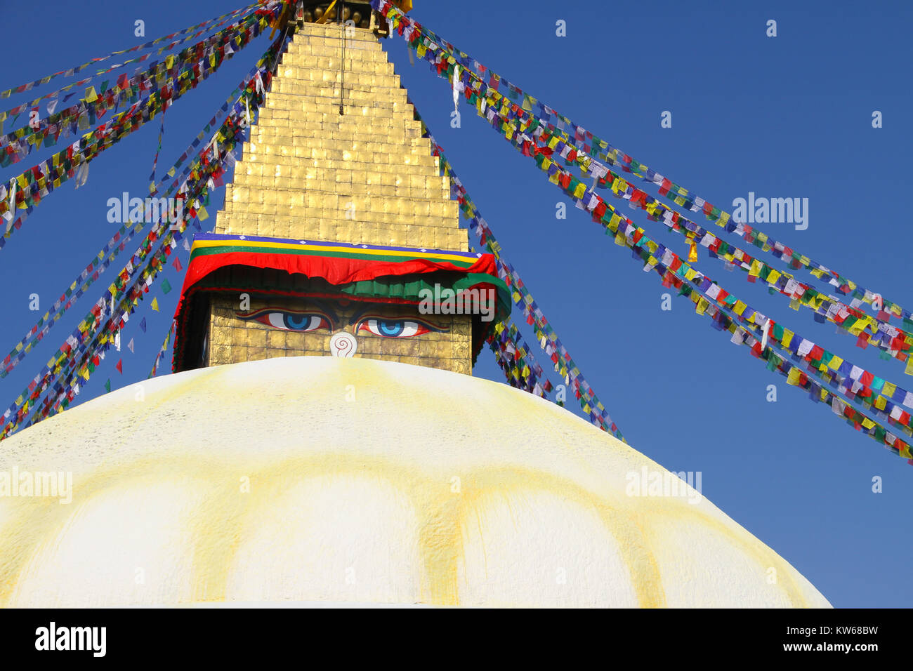 Prayer flags decending from golden topped stupa, Bhaktapur,  Nepal Stock Photo
