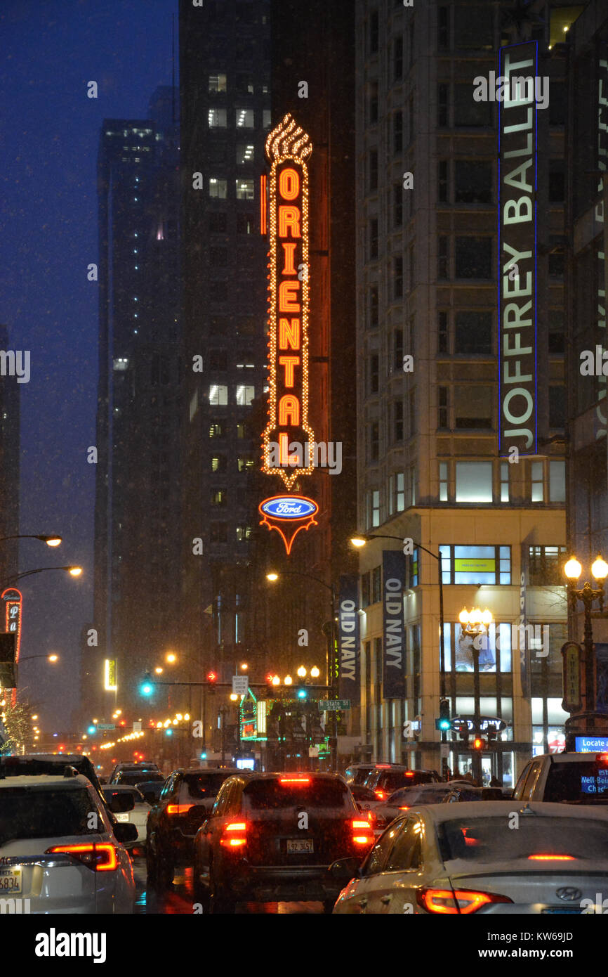 The Oriental Theater marquee glows above evening traffic on Randolph Street in Chicago's downtown theater district. Stock Photo
