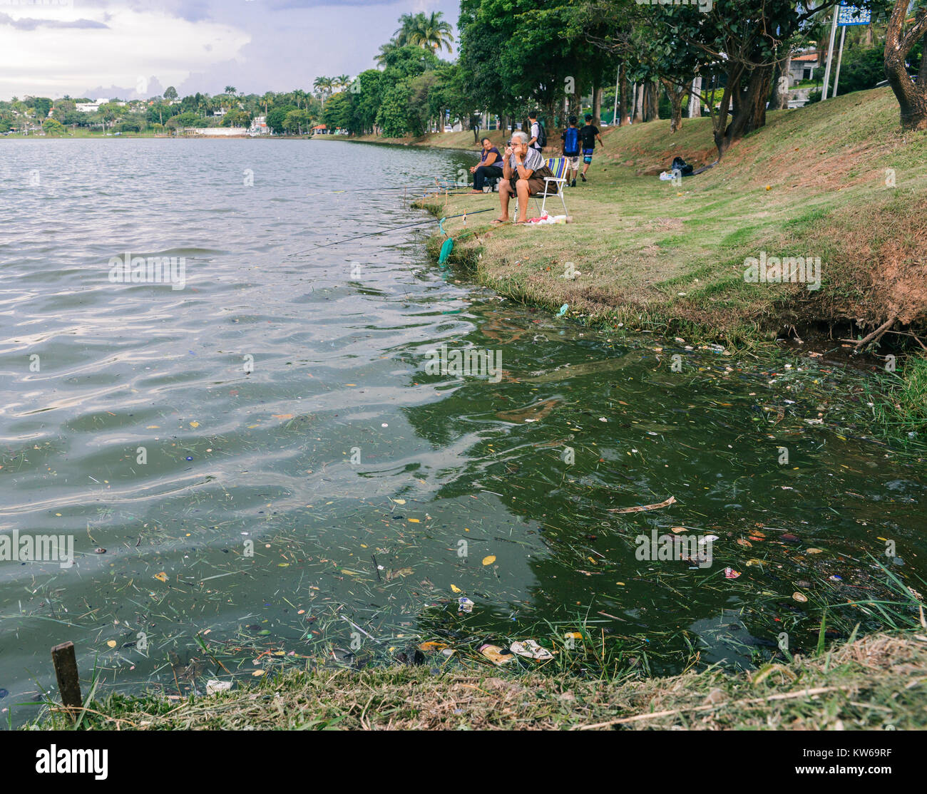 Belo Horizonte - Dec 26, 2017: Afro-Brazilian women fish on Pampulha lake, despite the pollution, in Belo Horizonte, Minas Gerais, Brazil Stock Photo