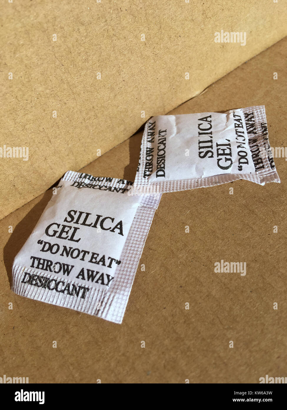 Two silica gel packets in cardboard box Stock Photo