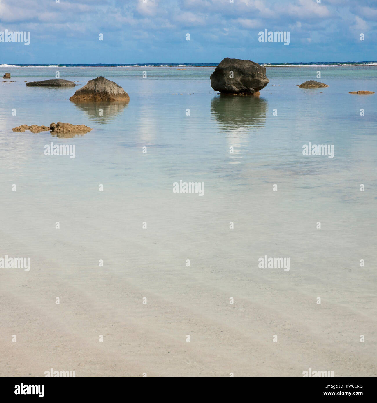 sun sea and sand scapes from the south pacific cook islands Rarotonga and one foot island with dramatic rock formations and reflections Stock Photo