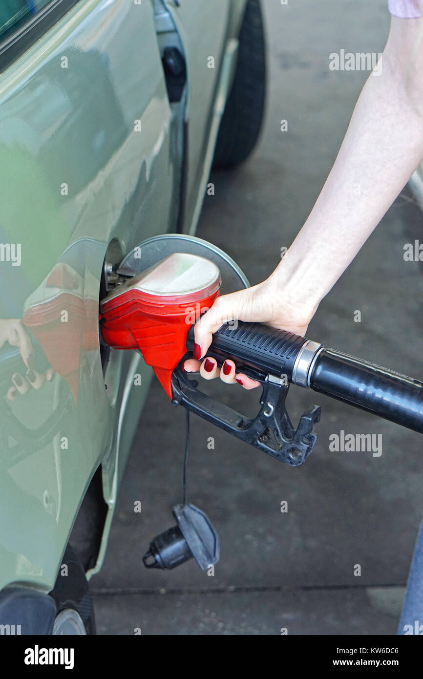 Woman filli up car with gas at petrol station Stock Photo - Alamy