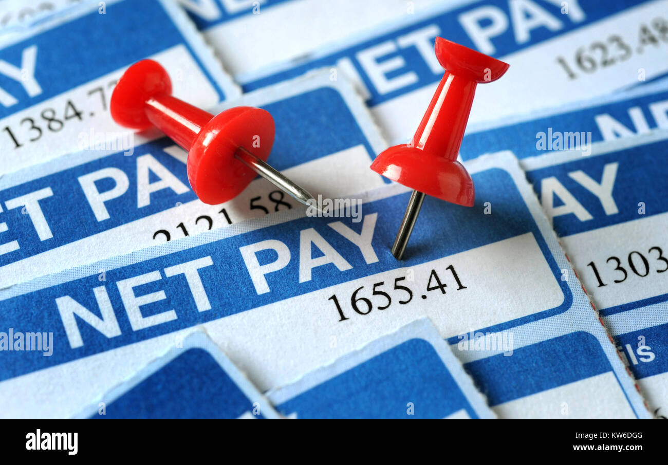 BRITISH PAYSLIPS SHOWING NET PAY AMOUNTS WITH RED NOTICEBOARD PINS UK Stock Photo