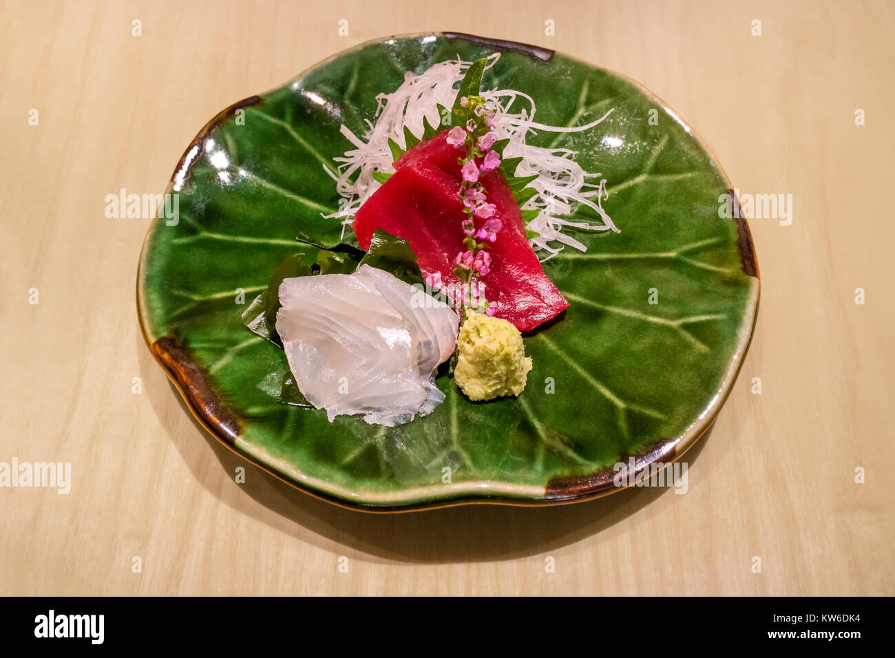 Tokyo - Japan, June 18, 2017; Traditional delicate served sushi dish decorated with wasabi and flowers Stock Photo