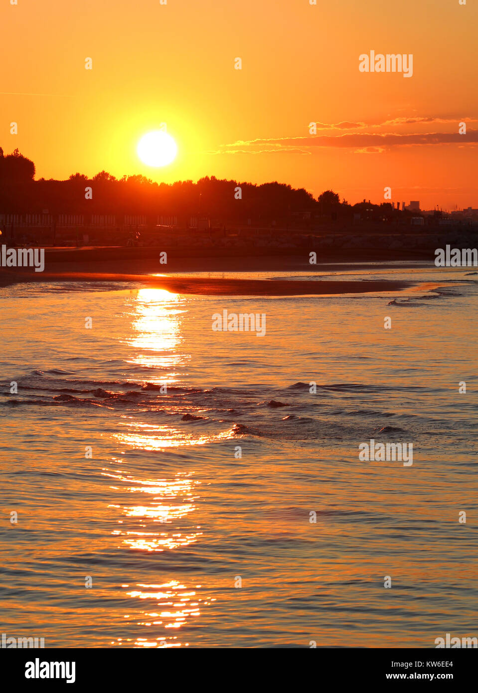 Wonderful sunrise with the big red sun and the reflection on the sea ...