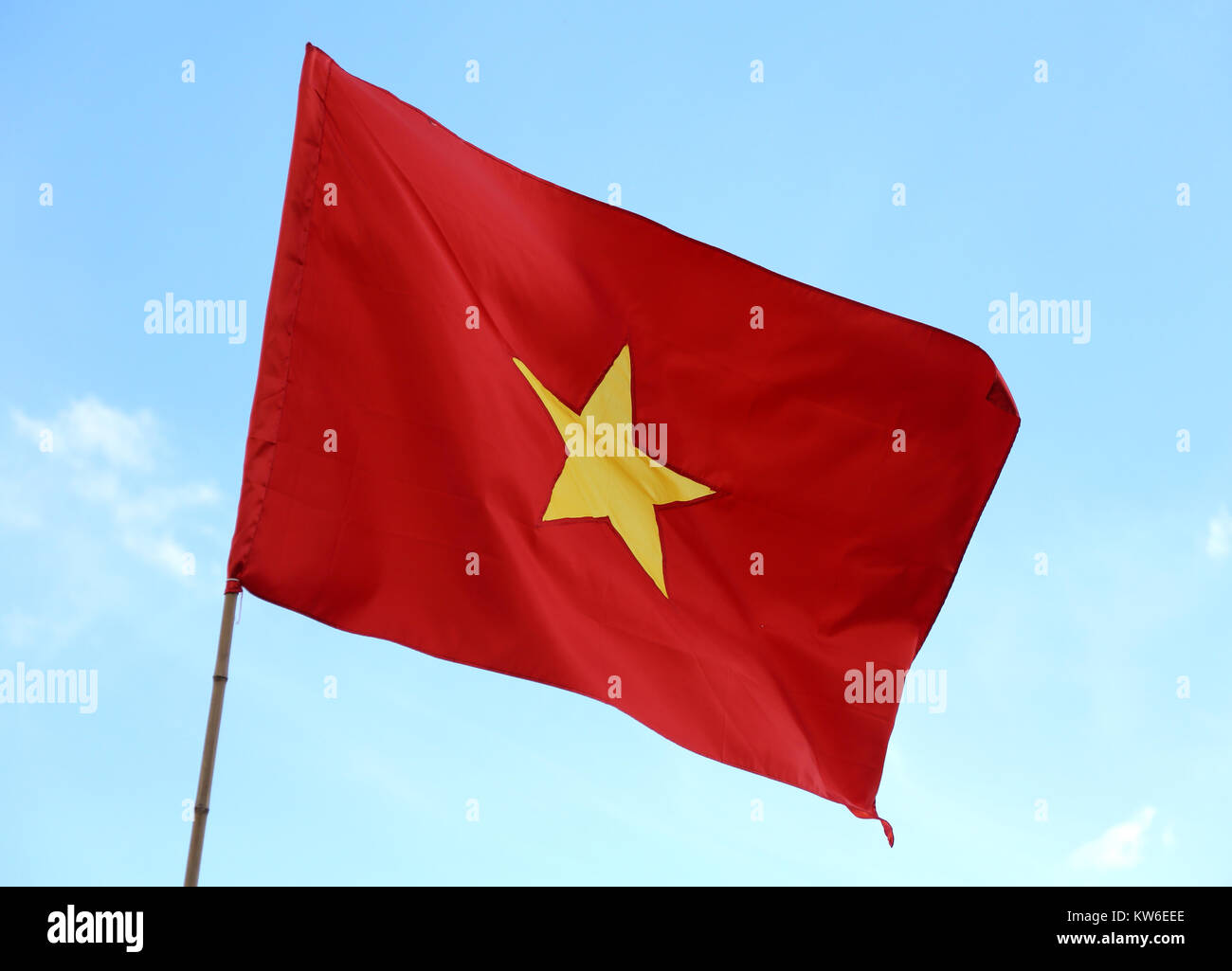 big flag of Vietnam with big yellow star in the red background with blue  sky Stock Photo - Alamy