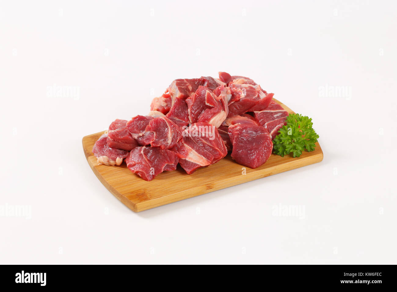 diced raw beef meat on wooden cutting board Stock Photo - Alamy