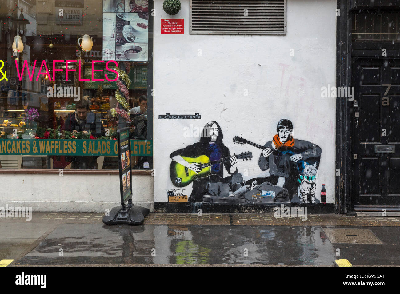 Street art depicting John Lennon and Paul McCartney on wall in Soho
