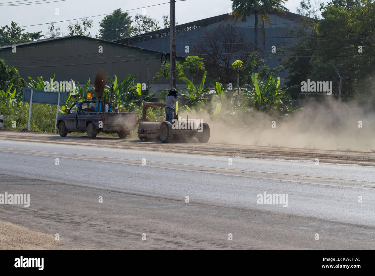 In Thailand this industrial street sweeper is pulled by a car Stock Photo