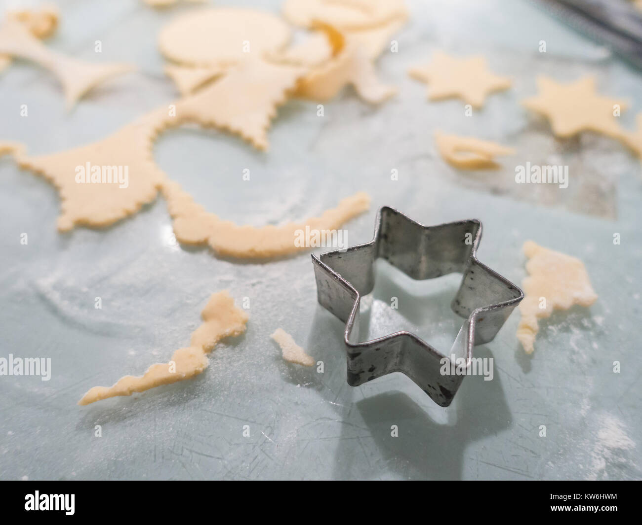 Making Mince Pies: Cutting shapes out of rolled shortcrust pastry on a kitchen worktop to make mince pies. 3 of 16 Stock Photo