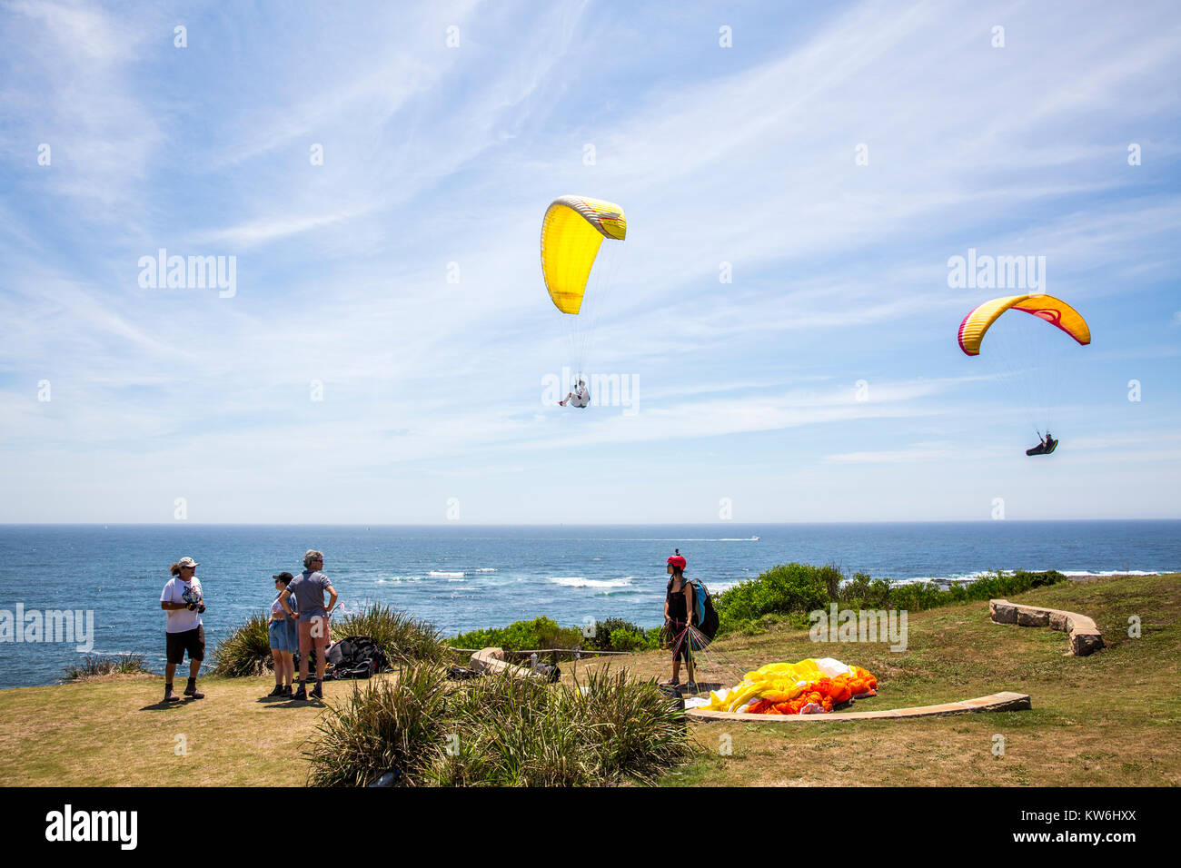 People paragliding and hang gliding at long reef point, Long Reef acquatic reserve,Sydney,Australia Stock Photo