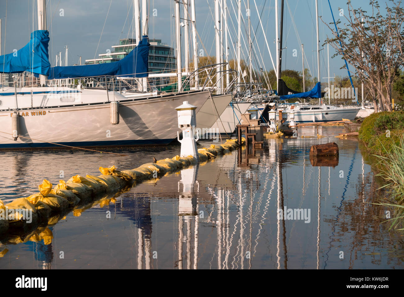 A flooded sidewalk and sandbags at Bronte Harbour Marina in Bronte