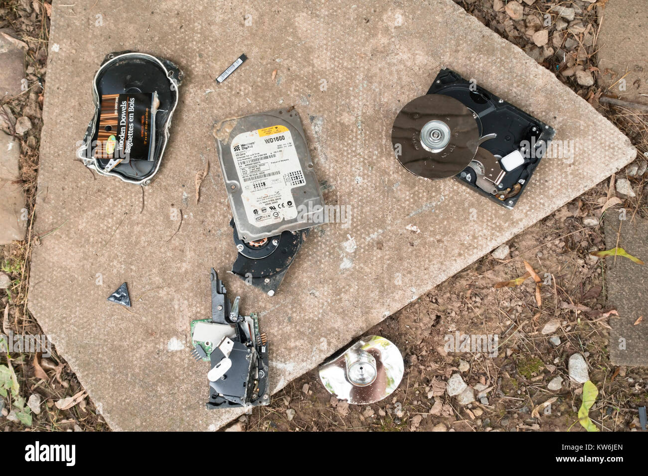 A broken hard disk drive HDD on the ground. Stock Photo