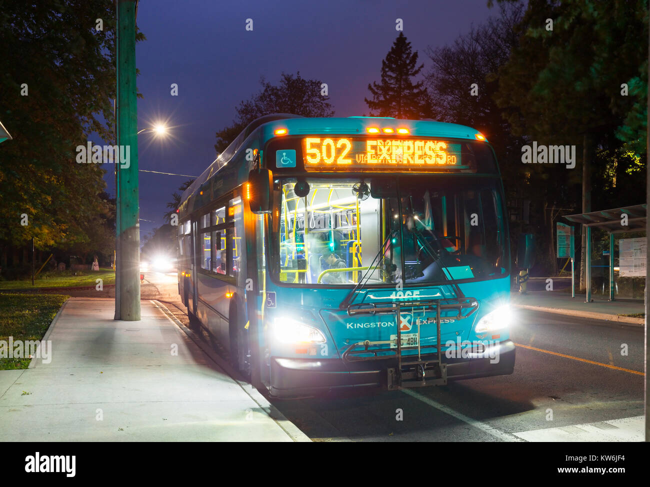 A Kingston Transit bus in particular Kingston Express bus at dusk in Kingston, Ontario, Canada. Stock Photo